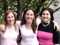 Three females with their arms over each other's shoulders